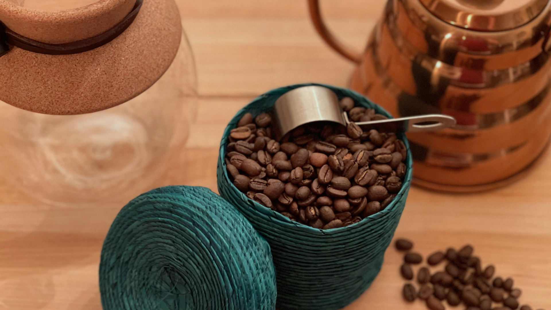 Knit basket with a display of roasted coffee beans with a V60 pour Over & Goose Neck kettle in the background.